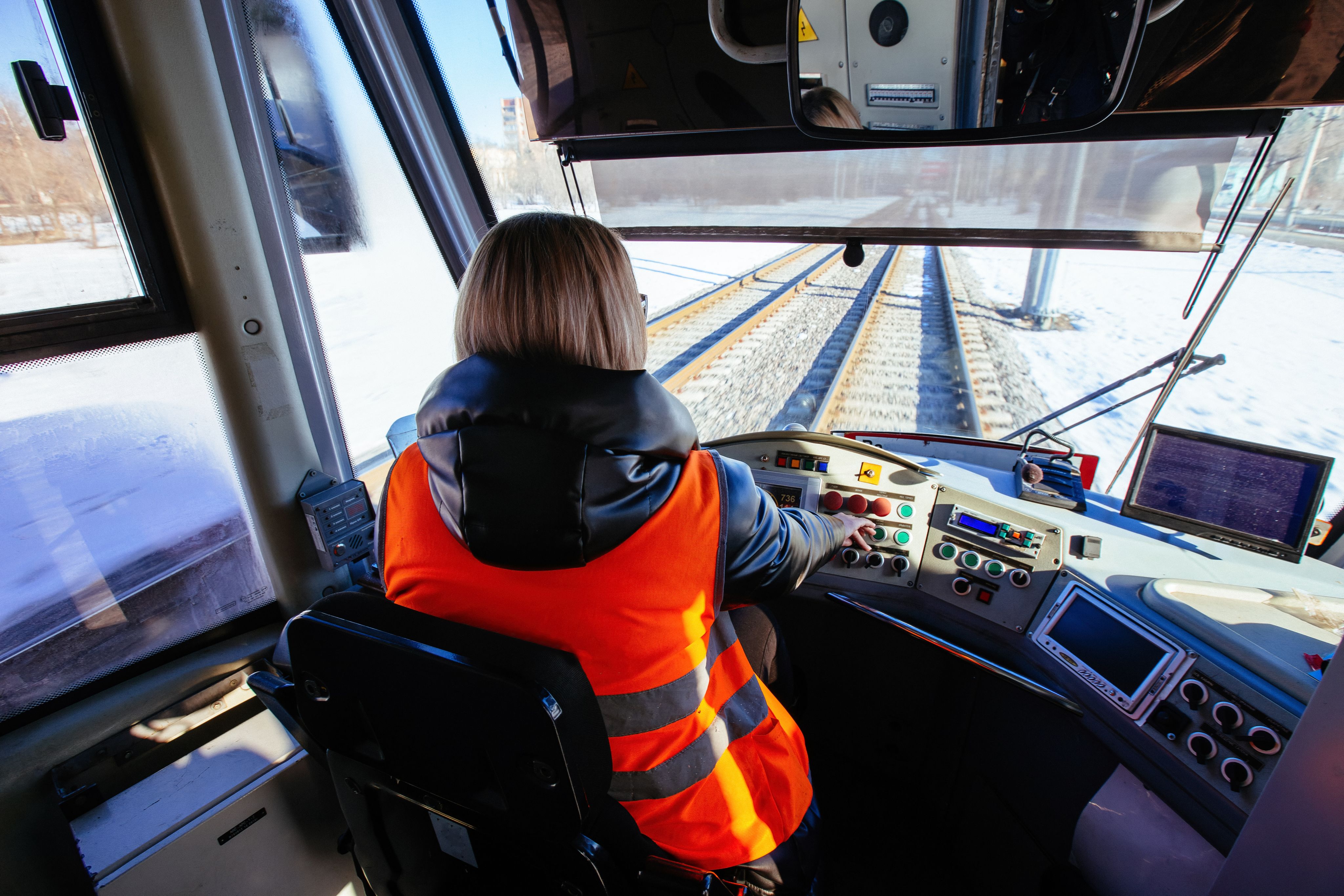 Female tram driver operating the tram, view from behind - Copyright - Mulderphoto / Adobe Stock