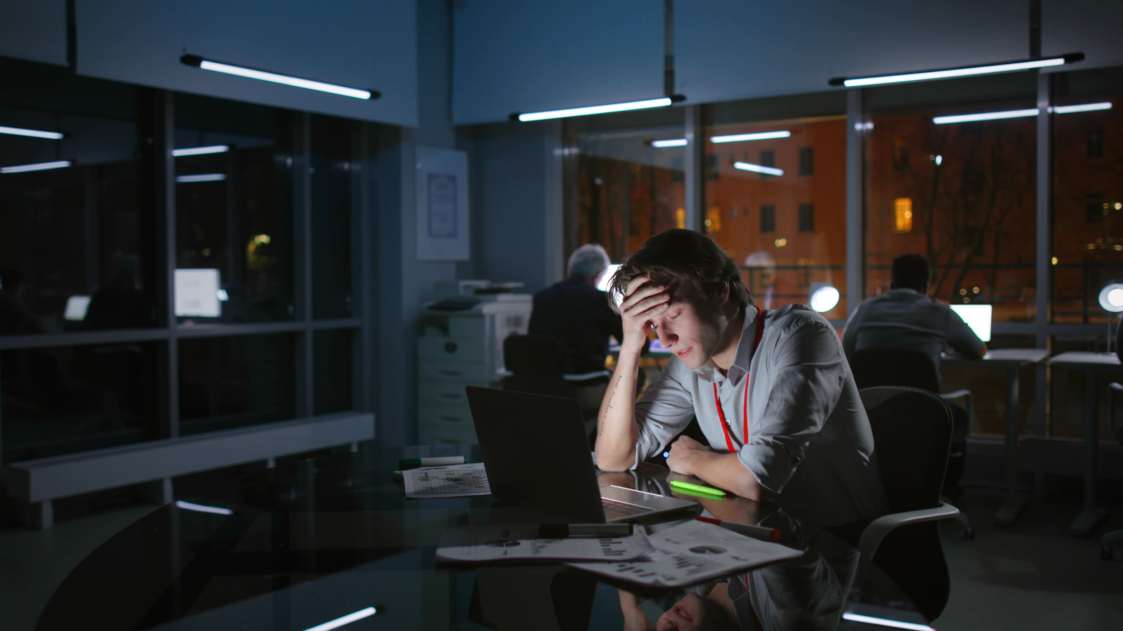 Man at work at night, exhausted and stressed - Copyright - nimito/ Adobe stock