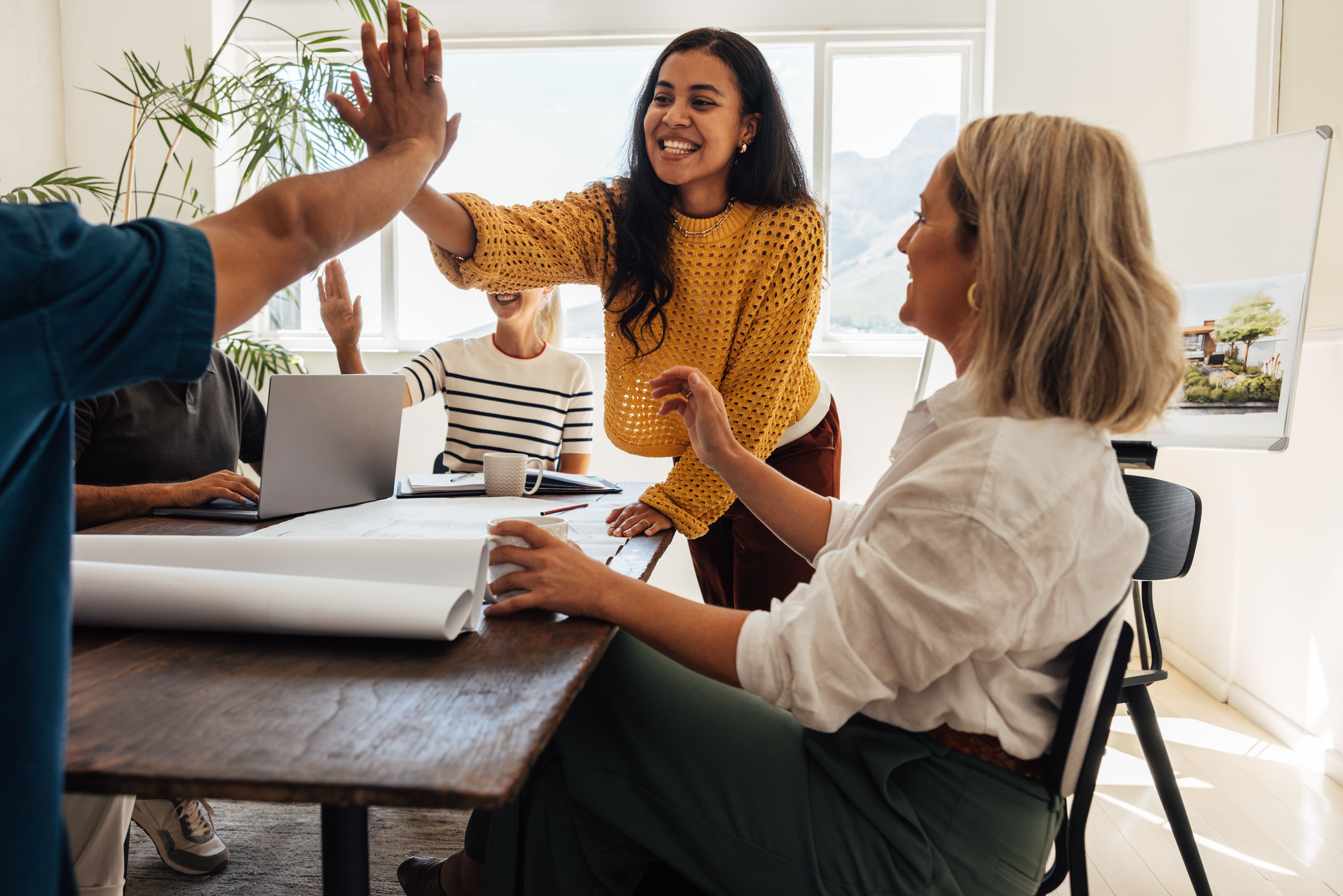 Architect team celebrating a success while working together in their office - Copyright - Jacob Lund / Adobe Stock