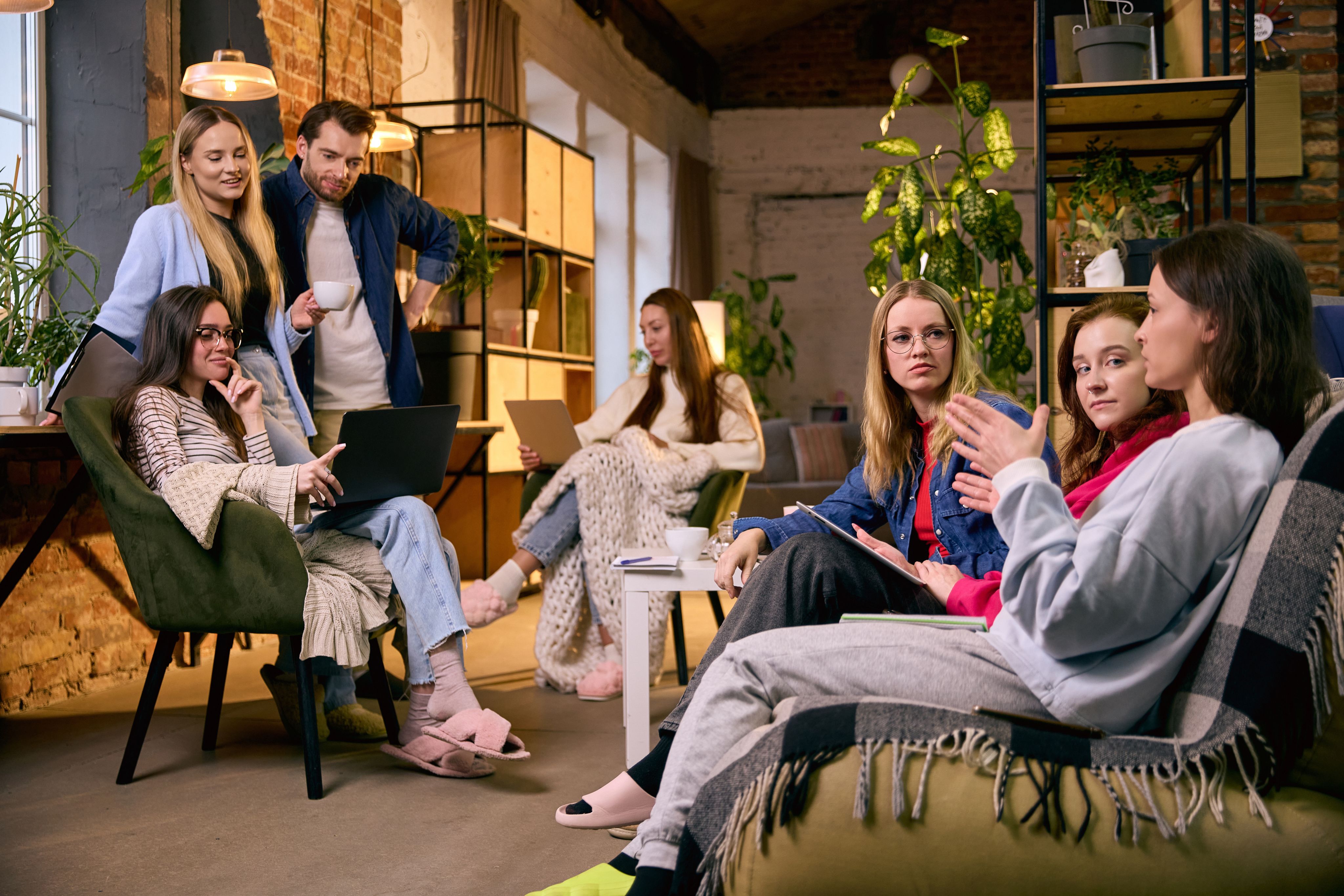 Mixed group of young workers in casual clothing in conversation over coffee - Copyright - master1305 / Adobe Stock