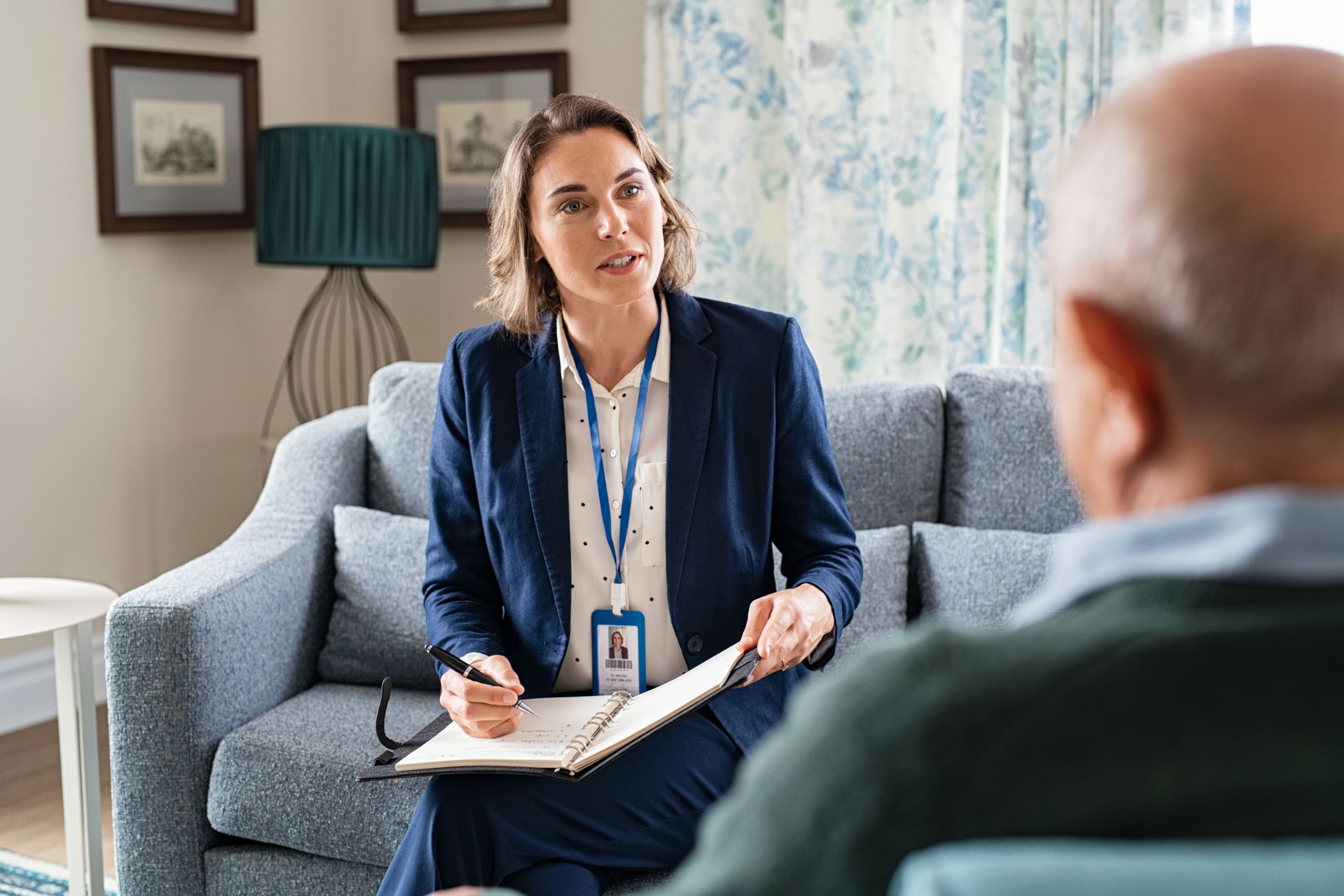 Female health professional talks to an elderly man - Copyright - Rido / Adobe Stock