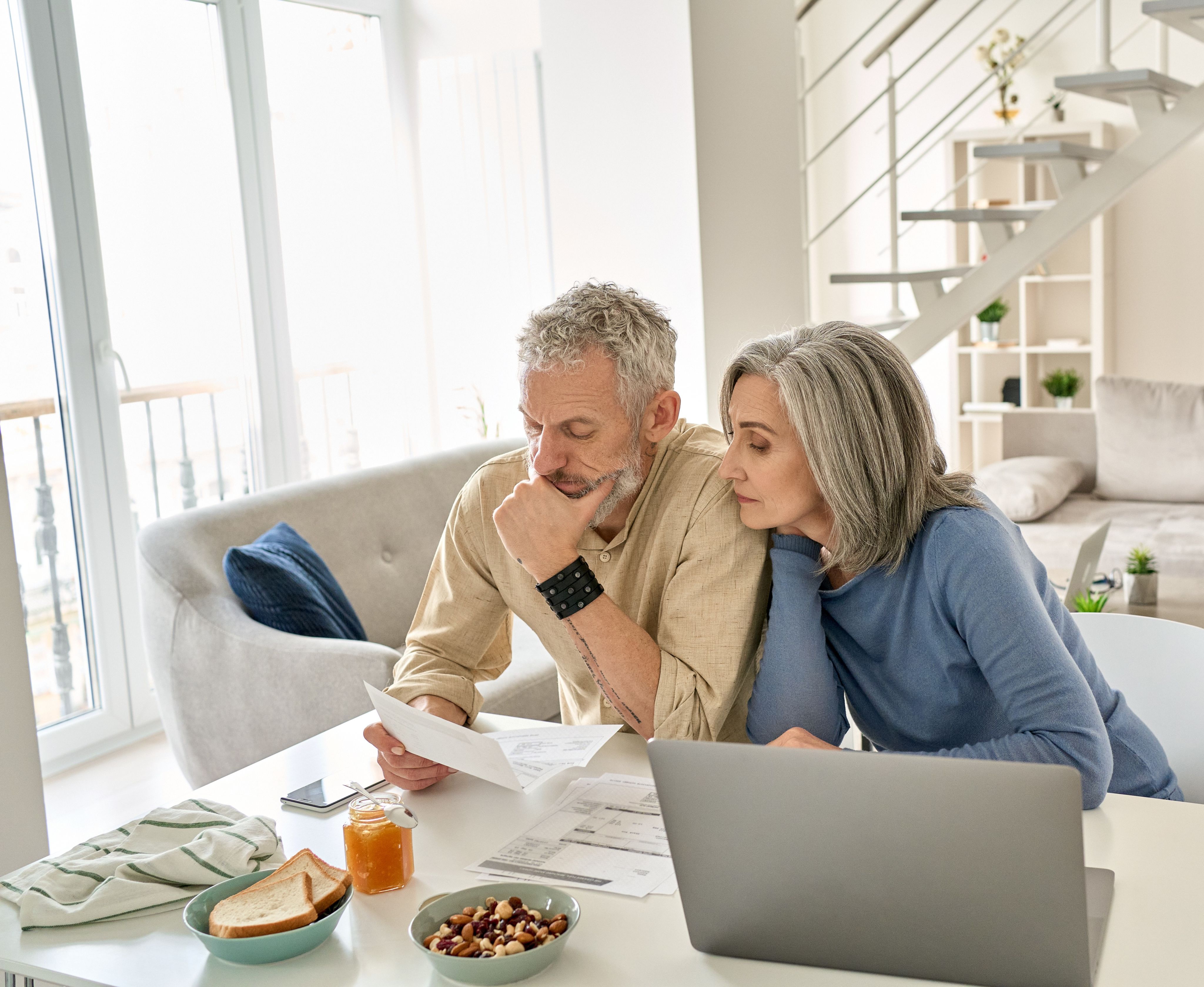 Older couple looking over their finances together- Copyright - insta_photos / Adobe Stock