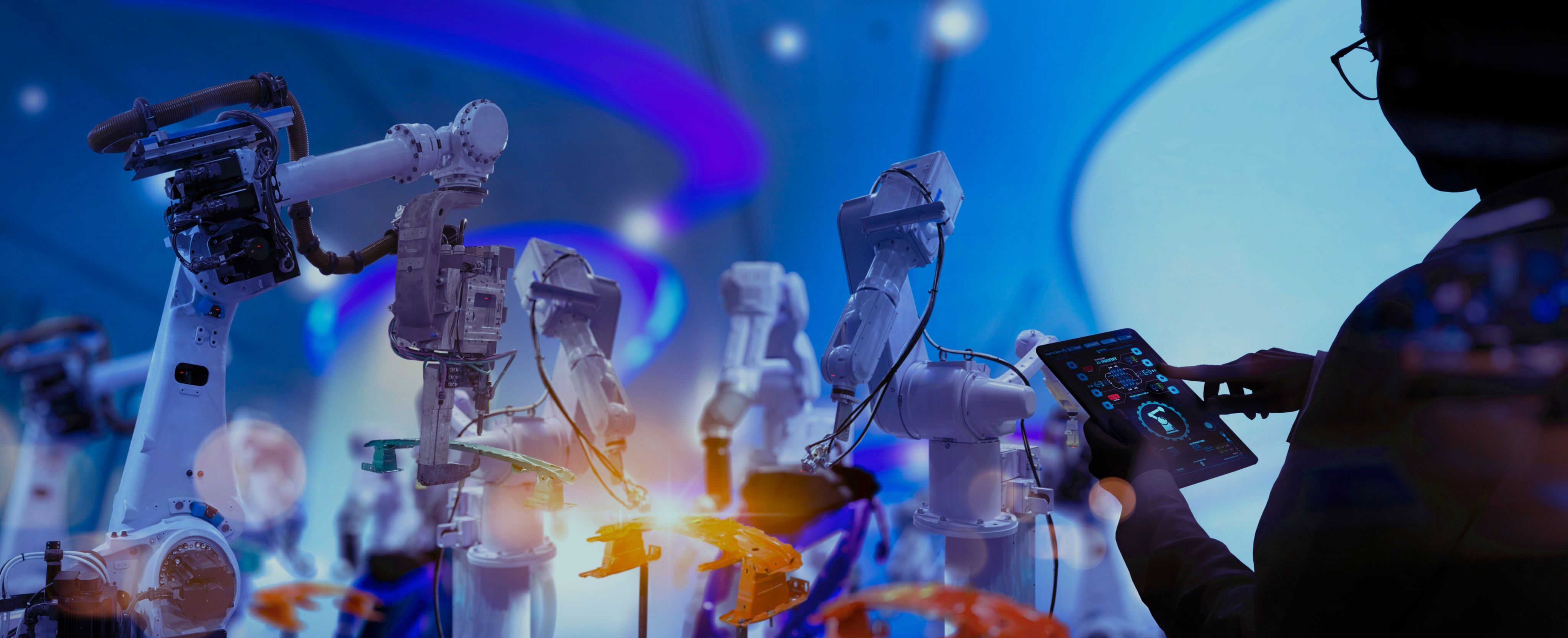 Robotic arms with a person controlling them with a tablet device