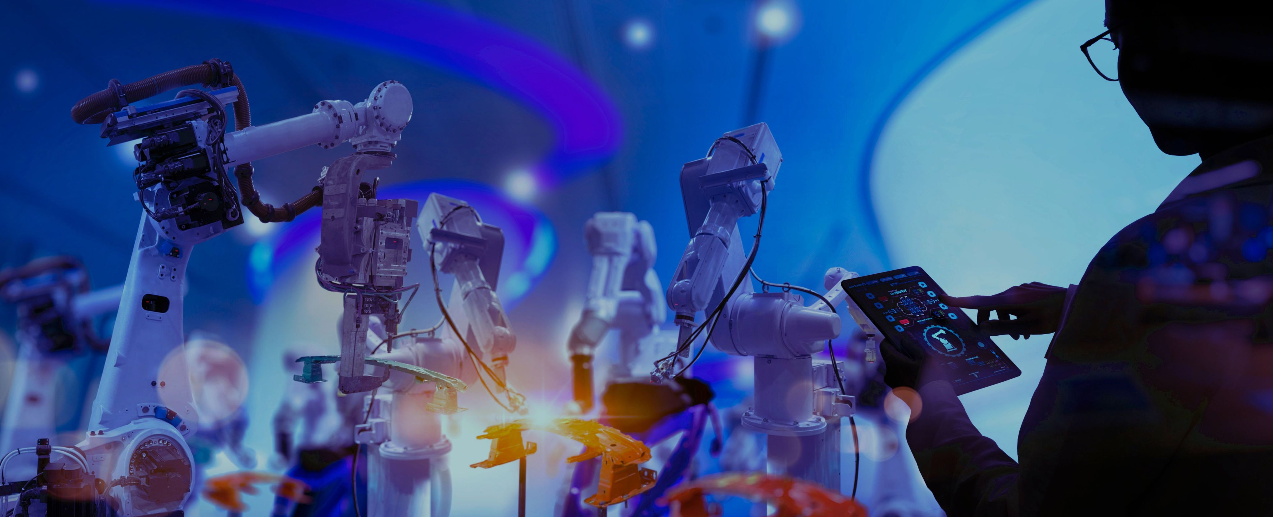 Robotic arms with a person controlling them with a tablet device