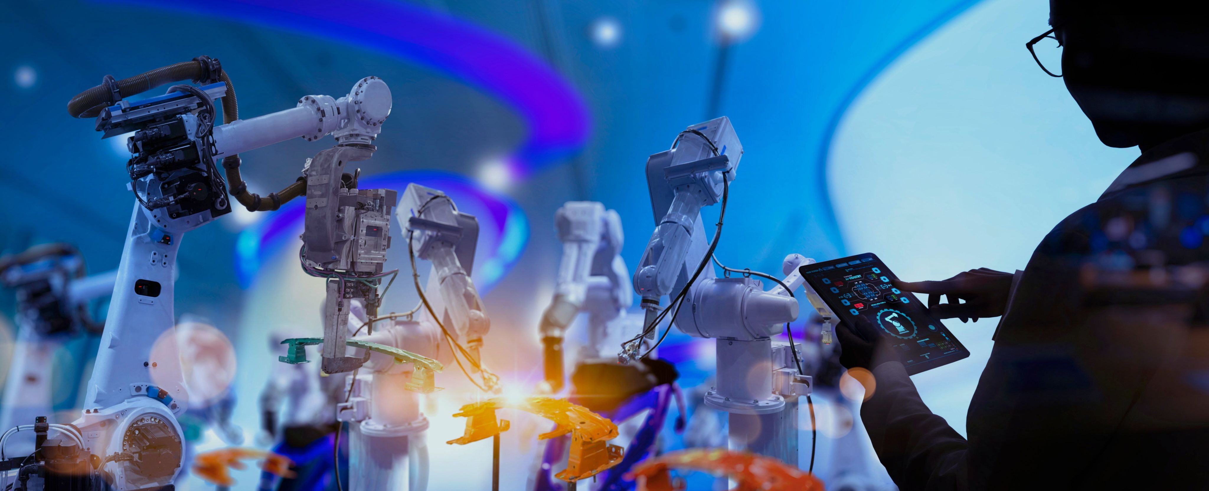Robotic arms with a person controlling them with a tablet device