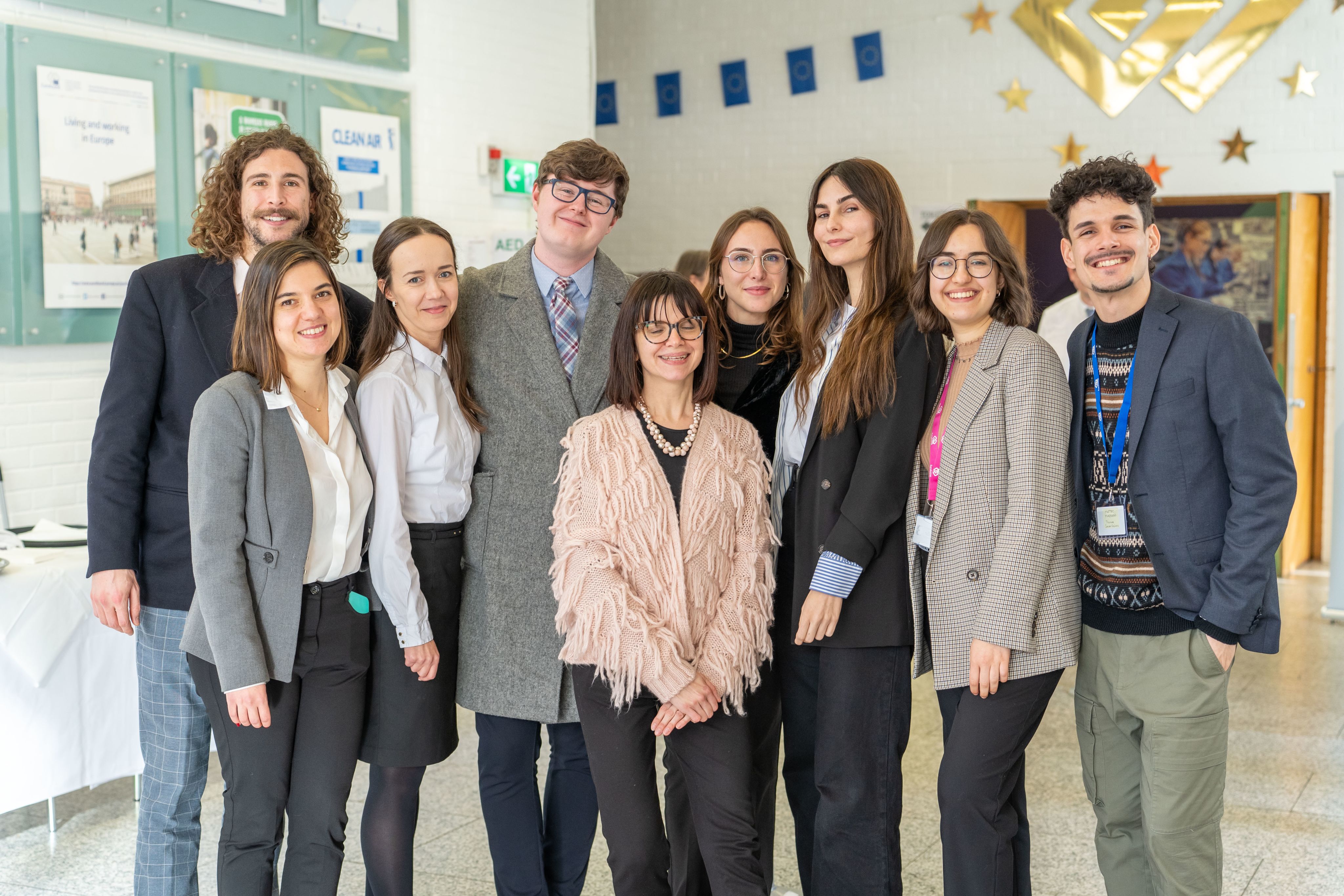 Group of Eurofound staff members smiling outside the conference centre