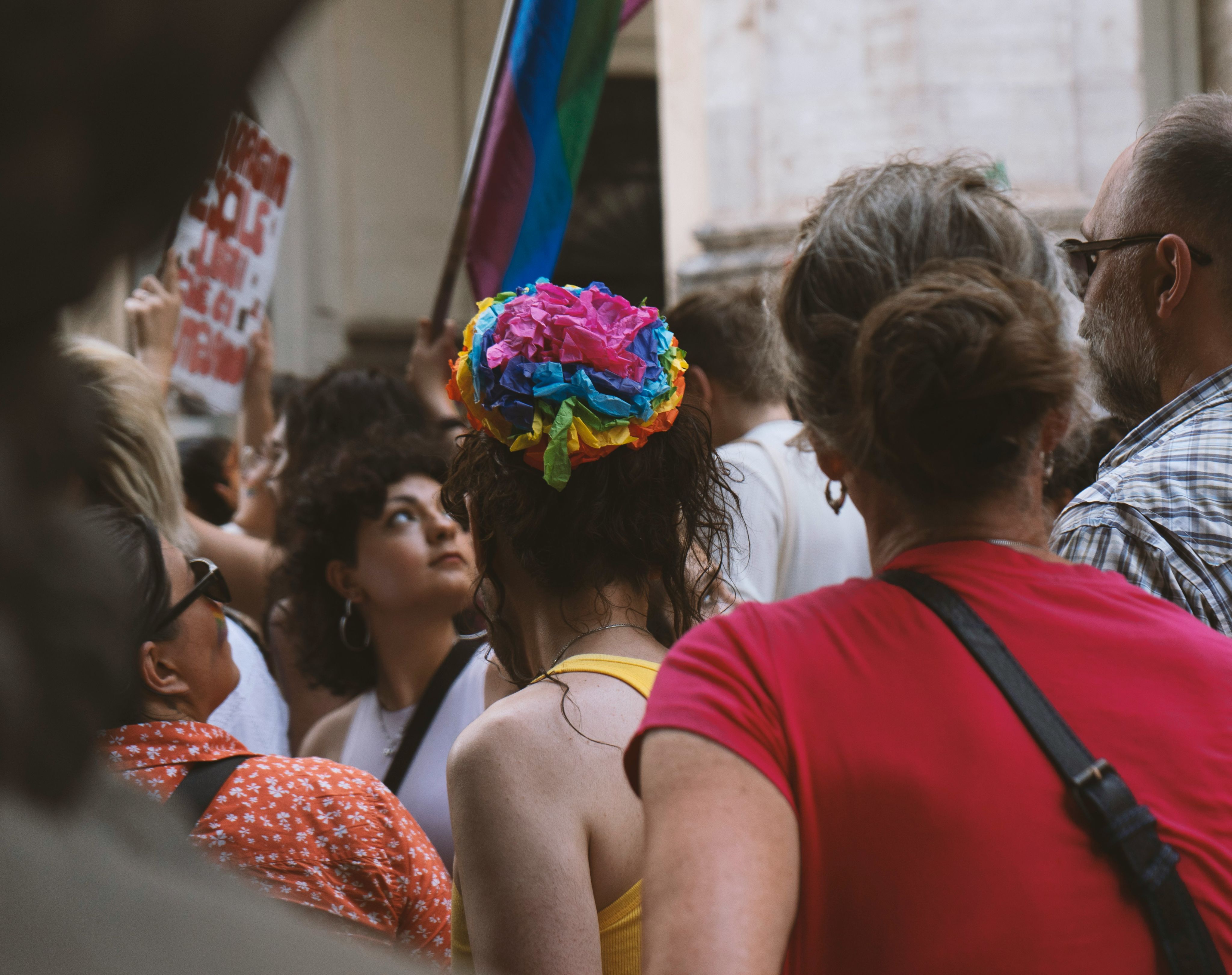 A crowd of people standing around each other